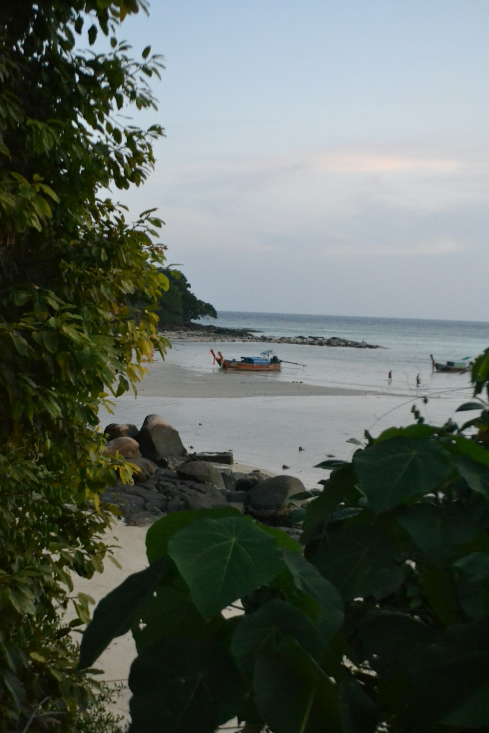 a view of a beach with a boat in the water