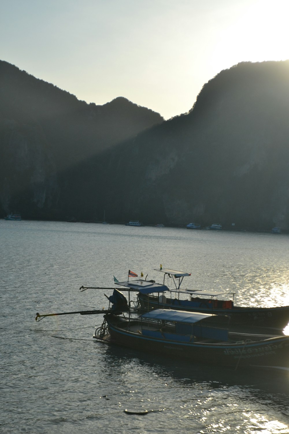 a couple of boats floating on top of a lake