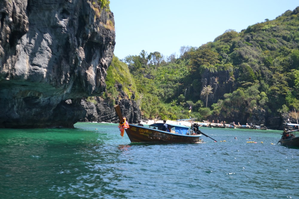 a couple of boats floating on top of a body of water