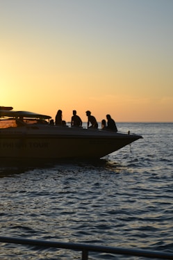 a group of people riding on the back of a boat