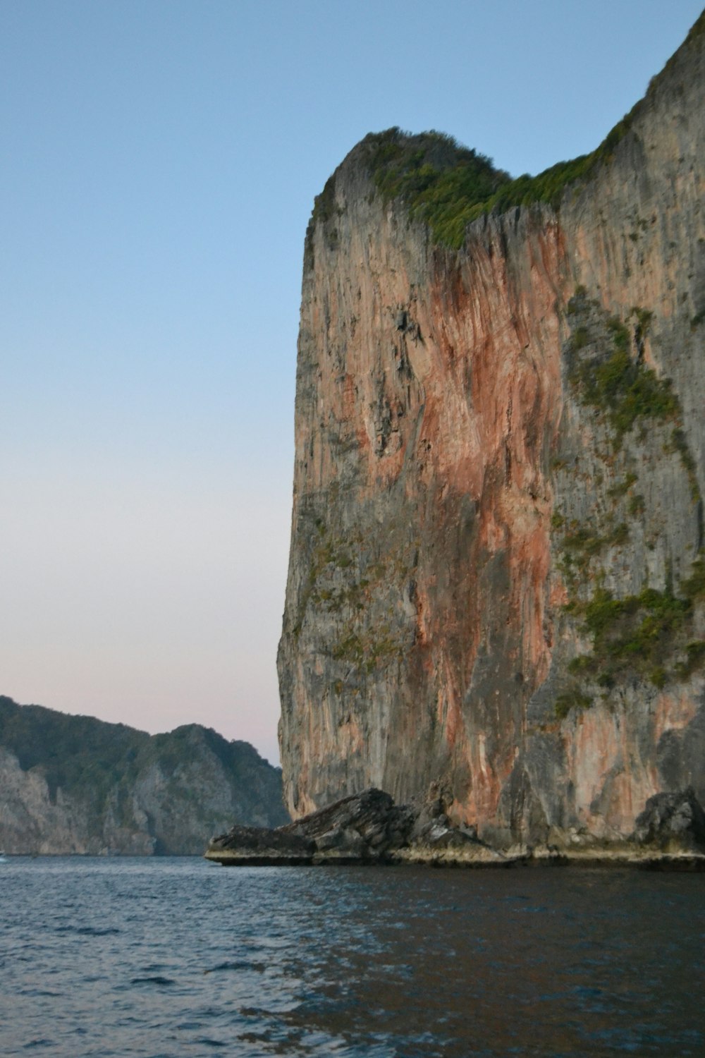 a large rock outcropping in the middle of a body of water