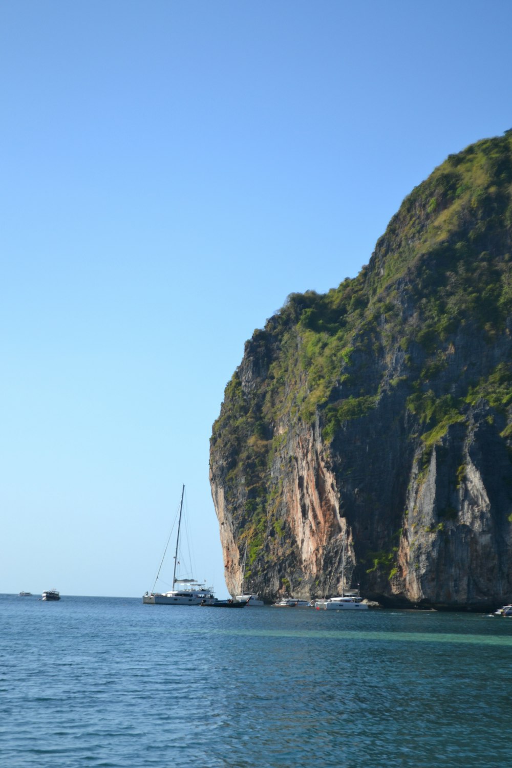 a boat is in the water near a mountain