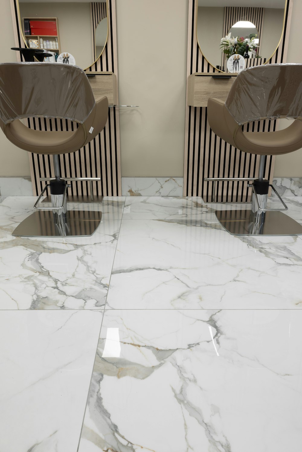a pair of chairs sitting on top of a marble floor