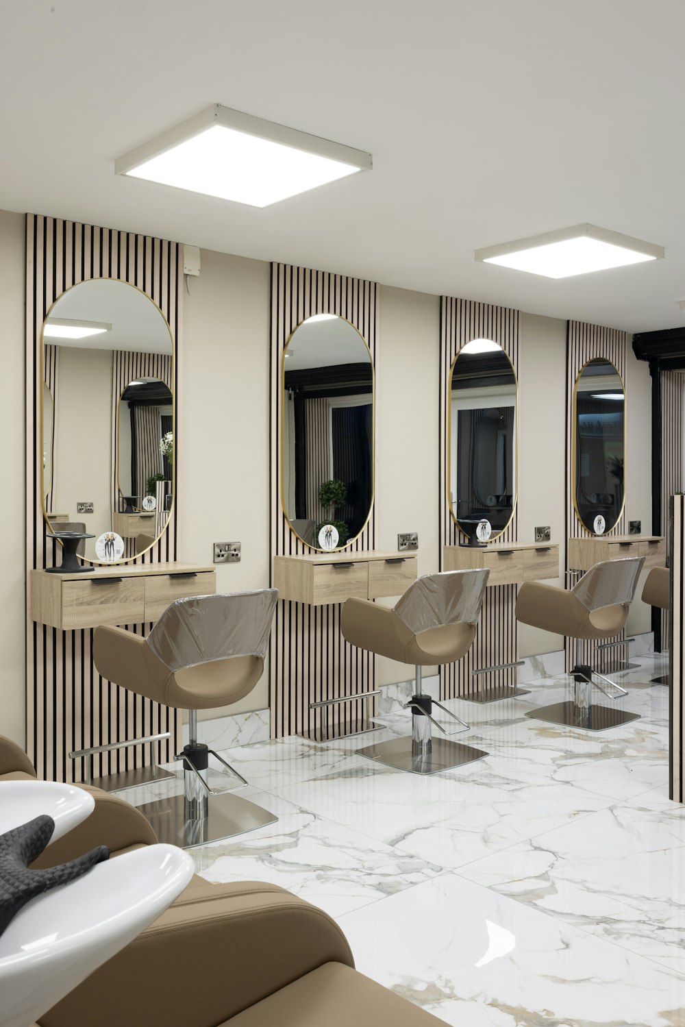 a hair salon with chairs and mirrors