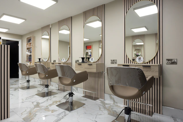 a hair salon with chairs and mirrors