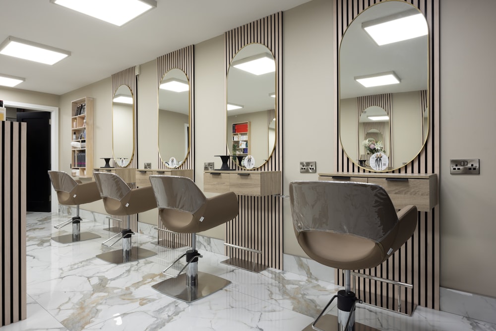 a hair salon with chairs and mirrors