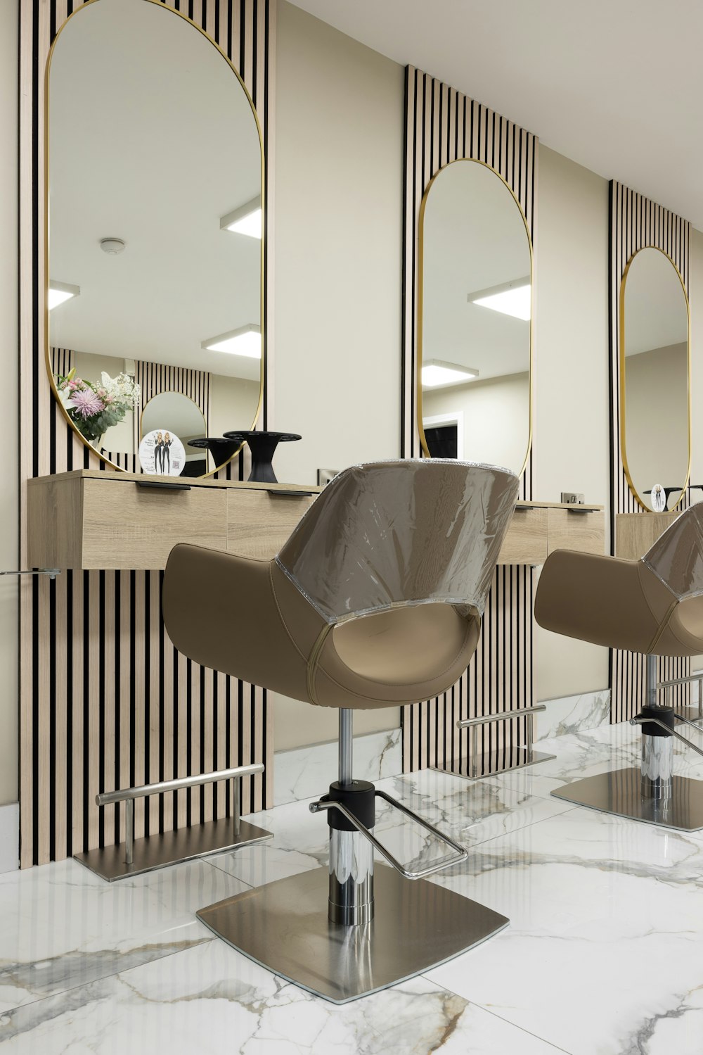 a hair salon with chairs and mirrors