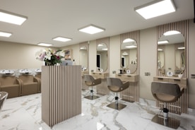 a room with a bunch of chairs and mirrors