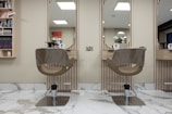 a hair salon with two mirrors and a chair