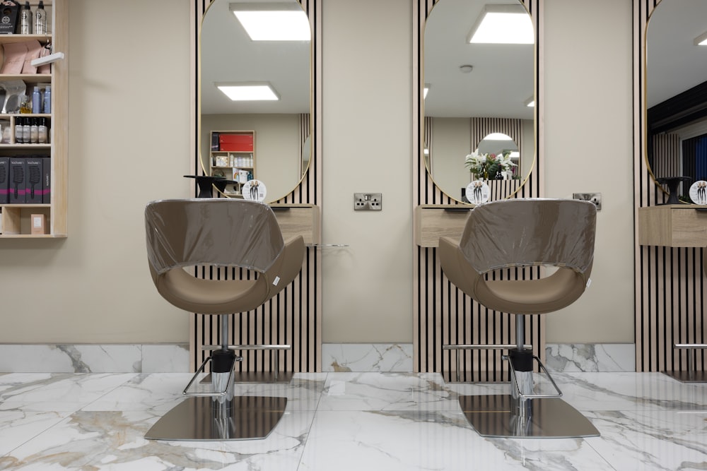 a hair salon with two mirrors and a chair