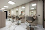 a hair salon with chairs and mirrors