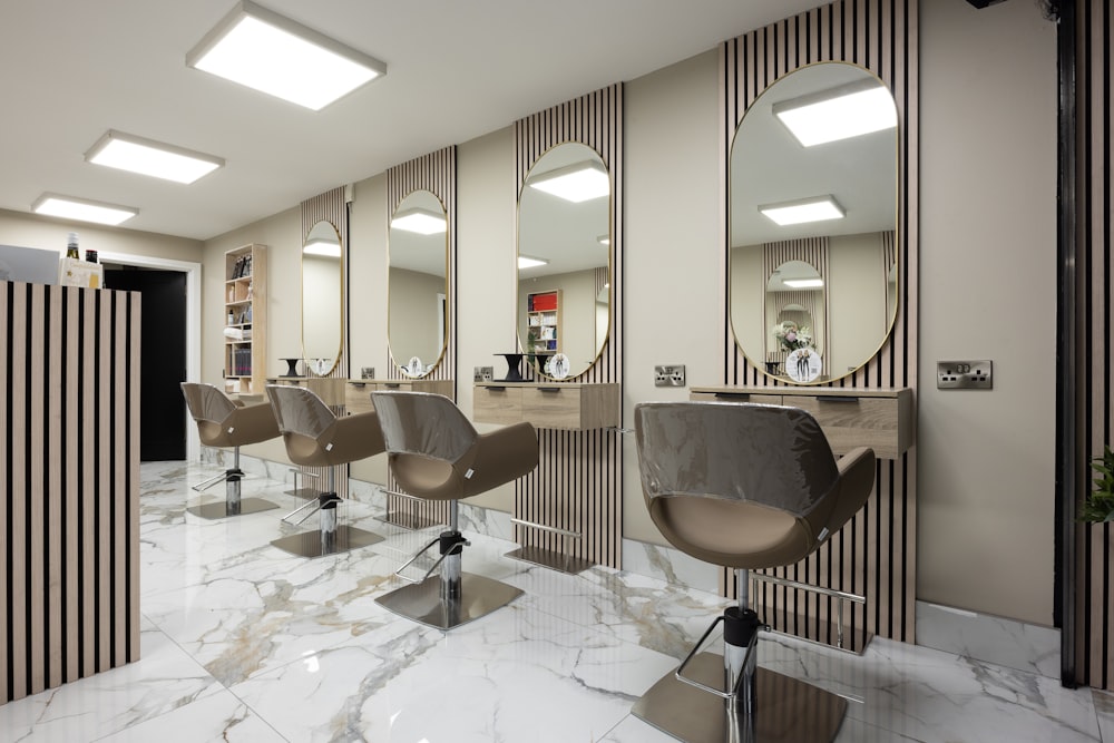 a hair salon with chairs and mirrors