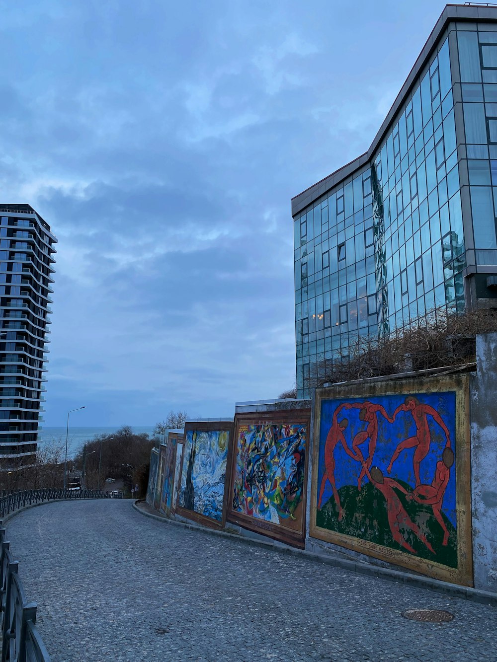 a row of paintings on the side of a building