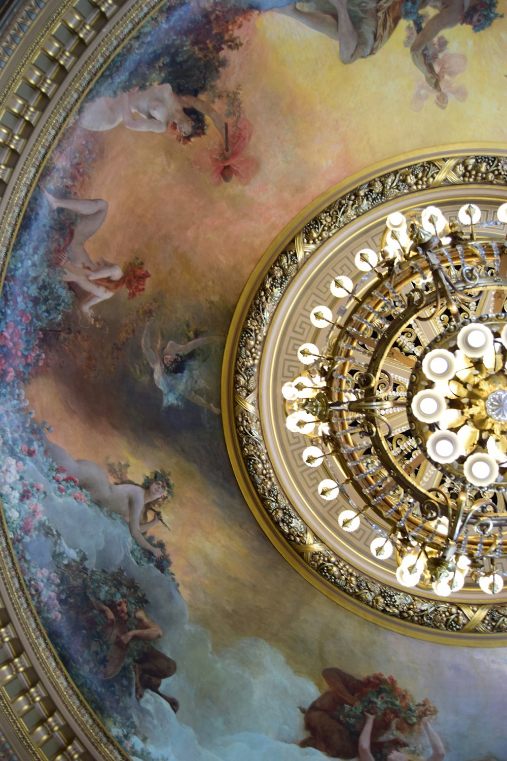 a ceiling with a painting of angels on it