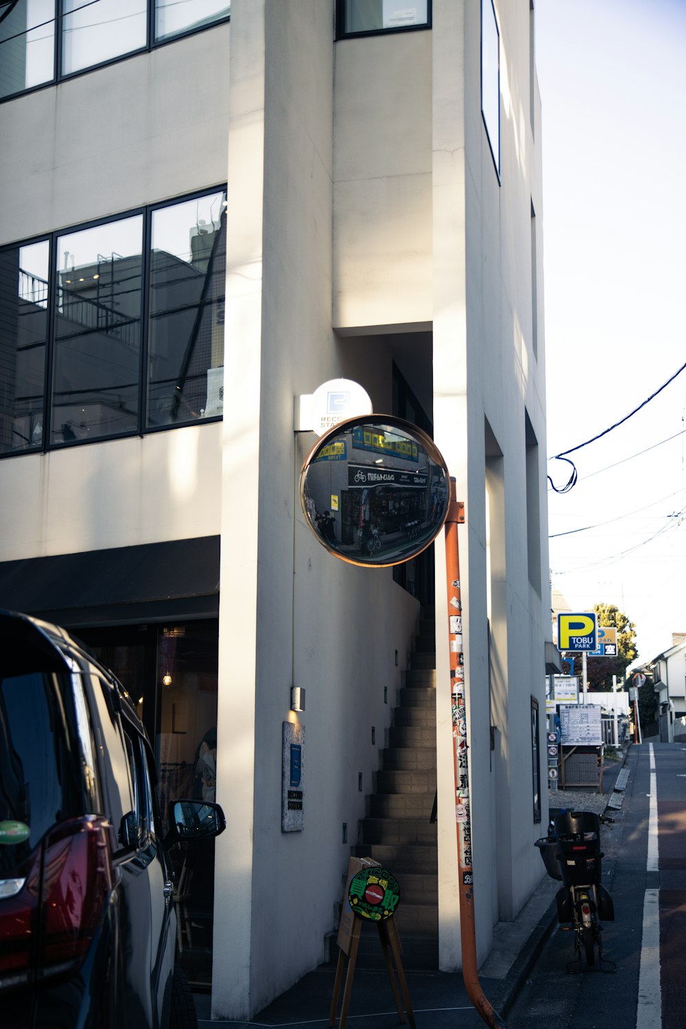 a car parked in front of a tall white building