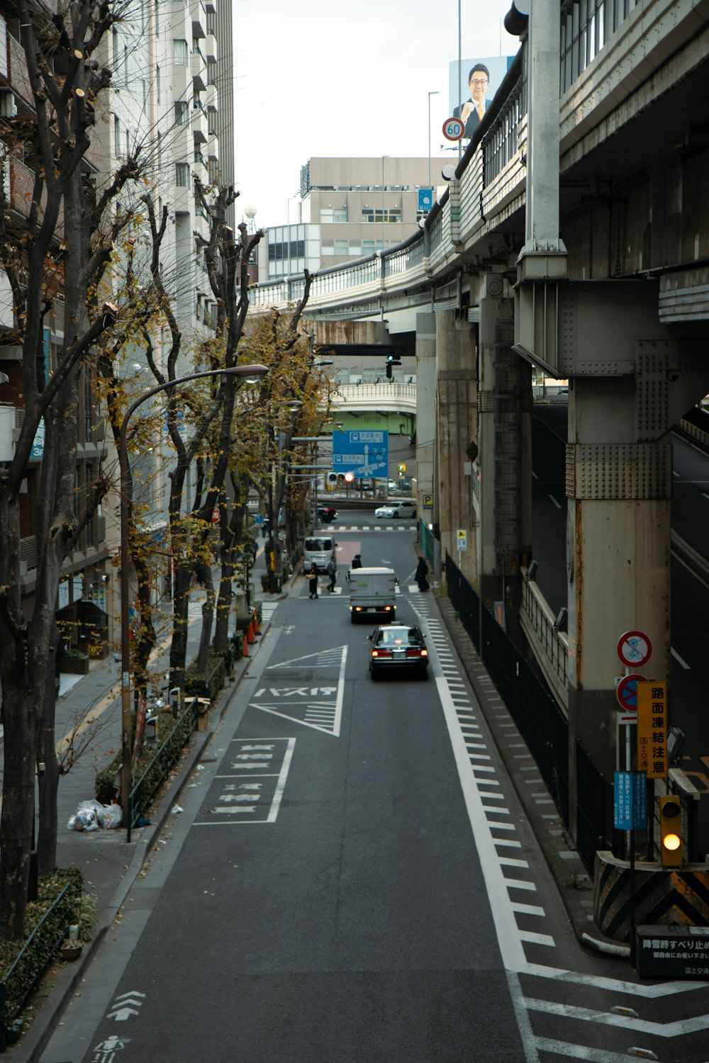 a car driving down a street next to tall buildings