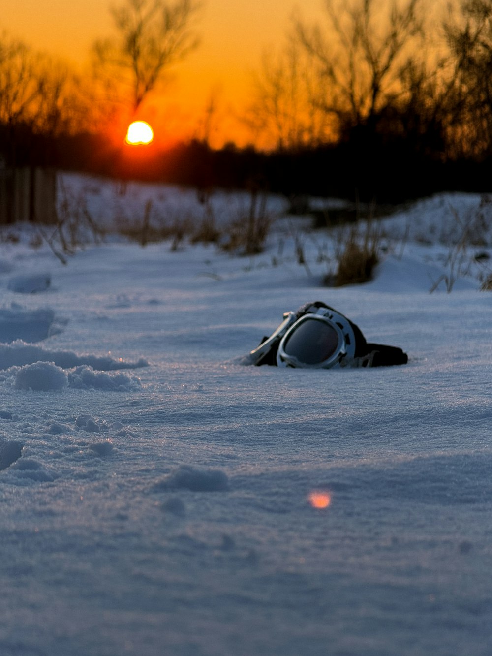 a pair of sunglasses laying in the snow