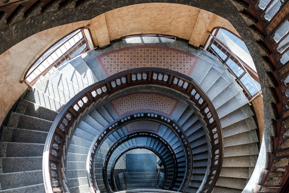 a spiral staircase in a building with a skylight