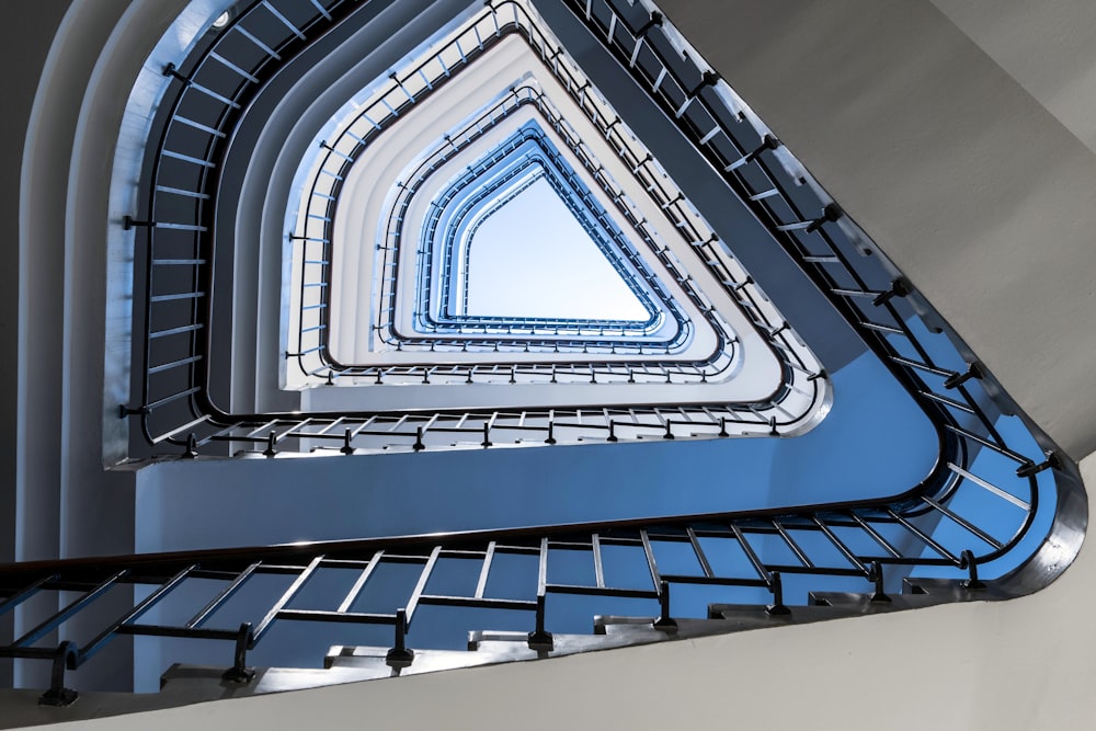 a spiral staircase with a blue sky in the background