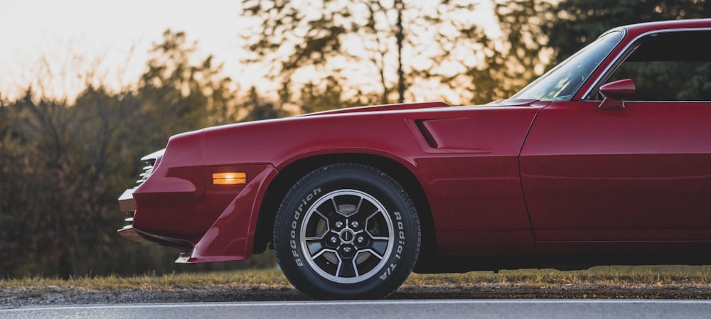 a red sports car parked on the side of the road