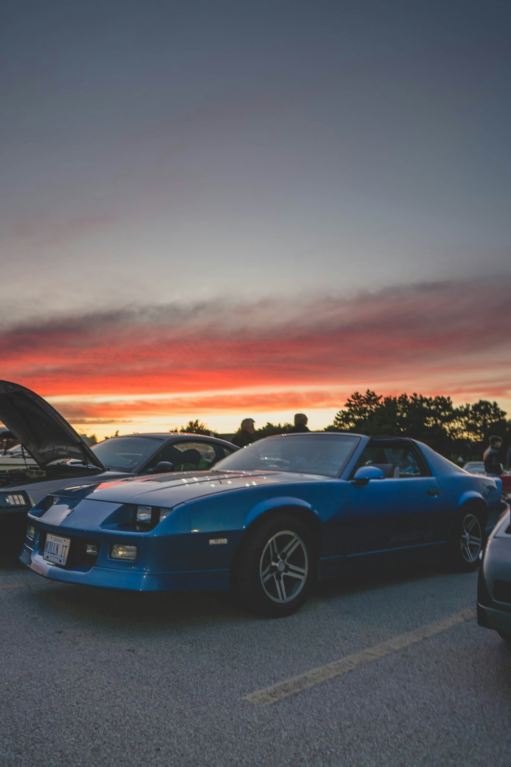 a couple of cars parked next to each other in a parking lot