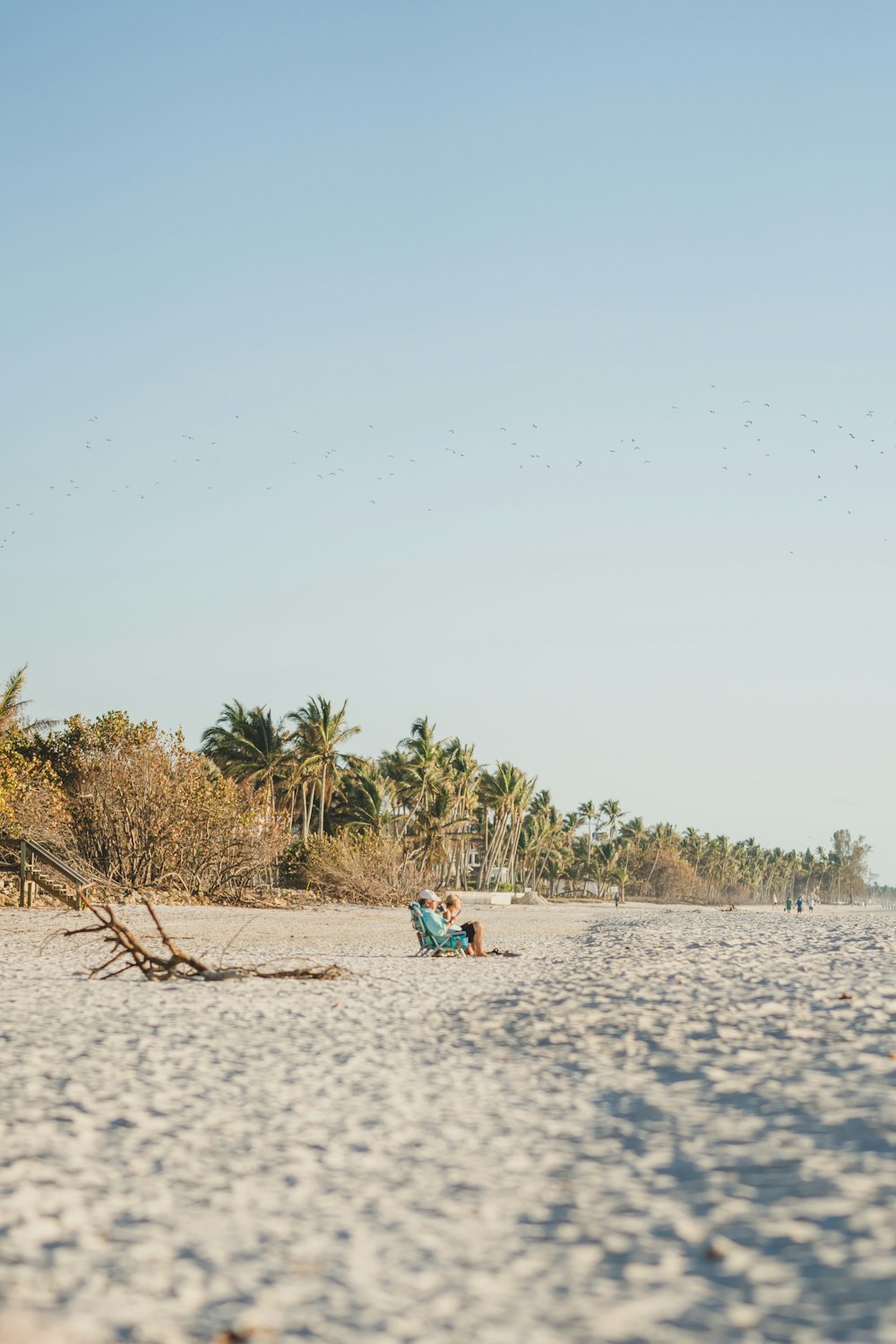 a person laying on a beach with a surfboard