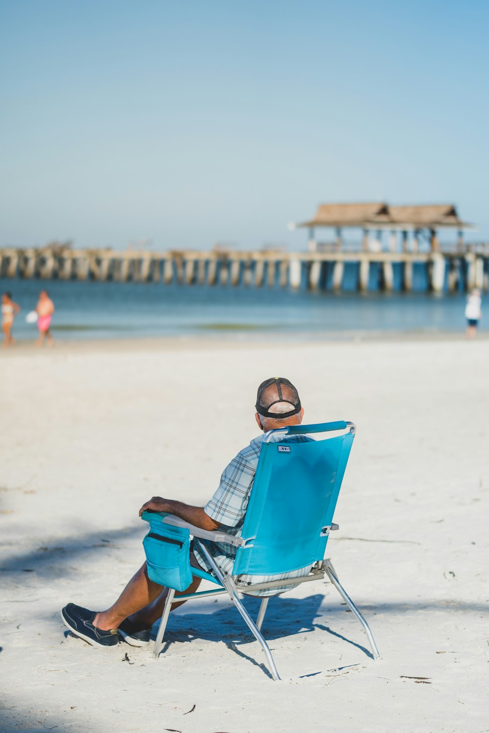 a man sitting in a chair on the beach