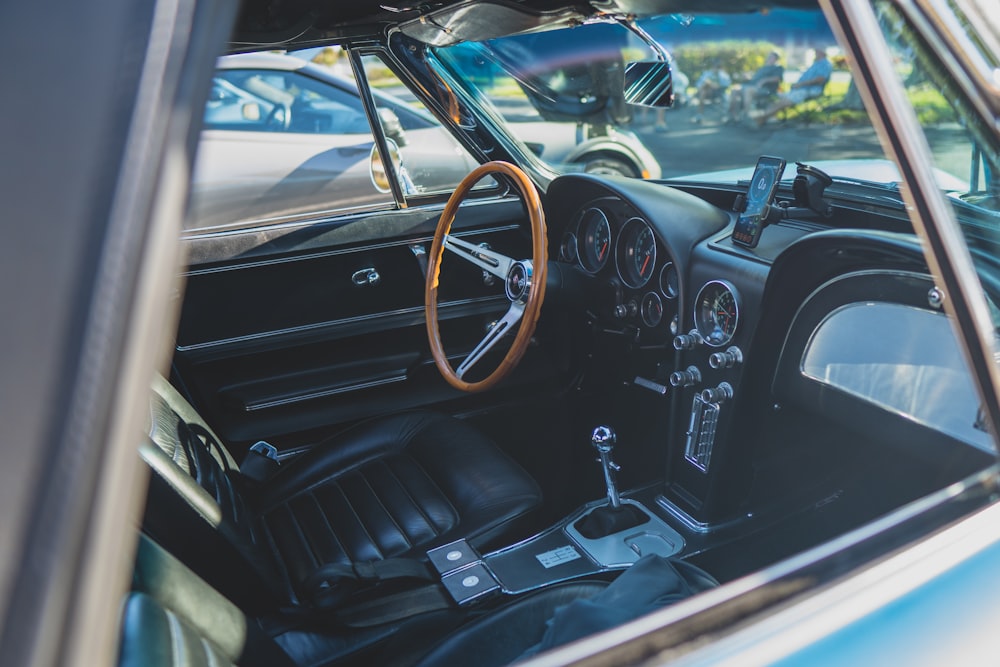 the interior of a car with a steering wheel and dashboard