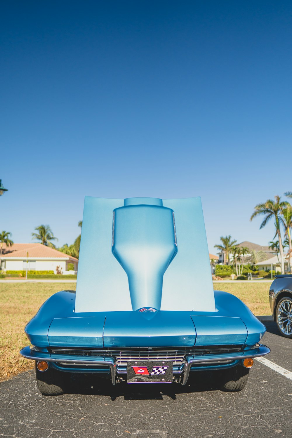 a blue car parked in a parking lot