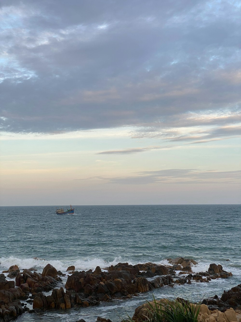 a large body of water sitting next to a rocky shore