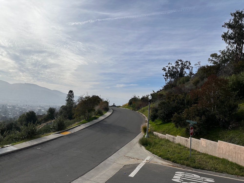 a curved road with a sign on the side of it