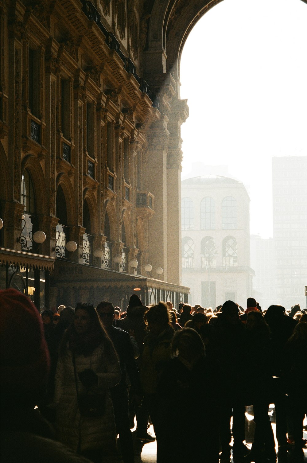 a group of people standing in front of a tall building