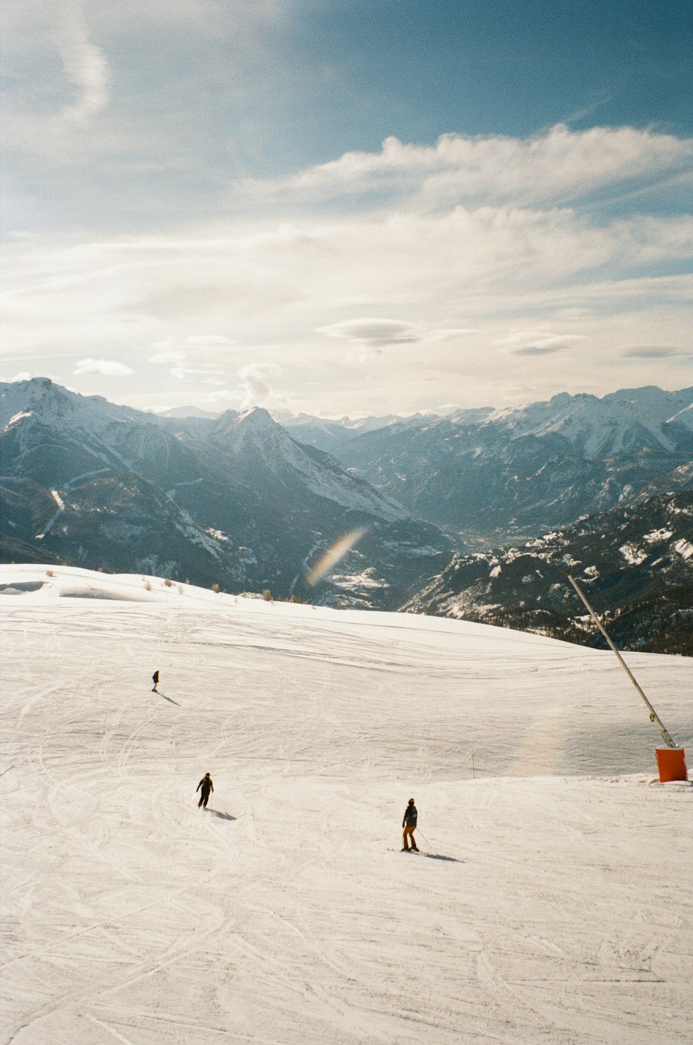 a group of people riding skis on top of a snow covered slope