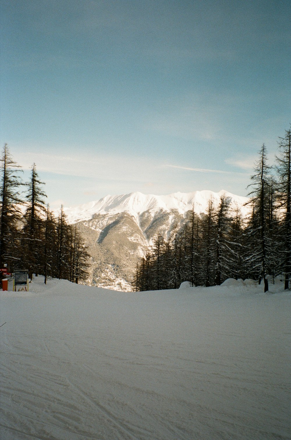 a person riding skis on top of a snow covered slope