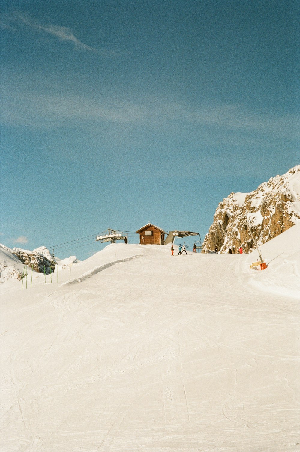 a person riding a snowboard down a snow covered slope