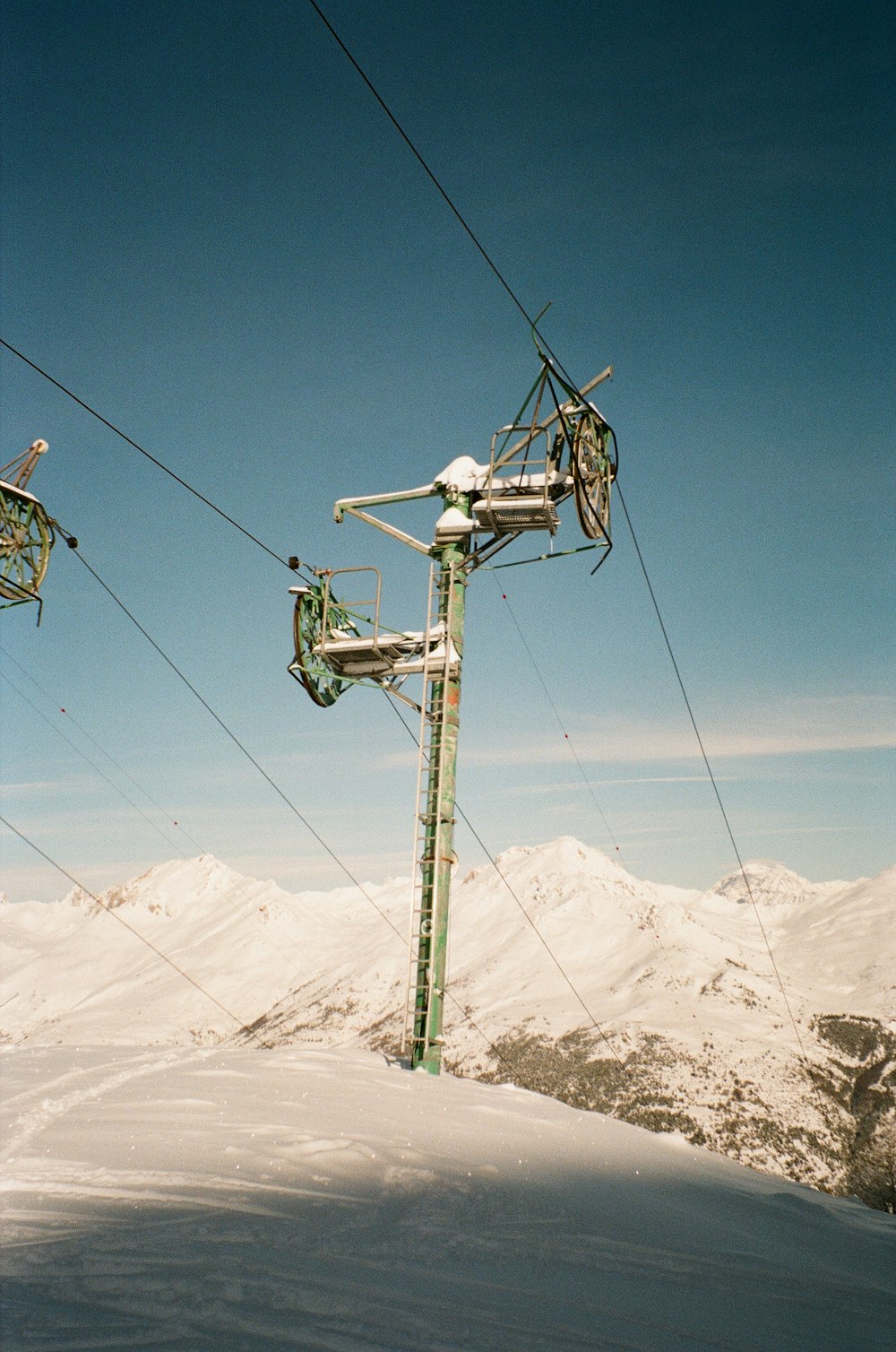 a ski lift going up a snowy mountain