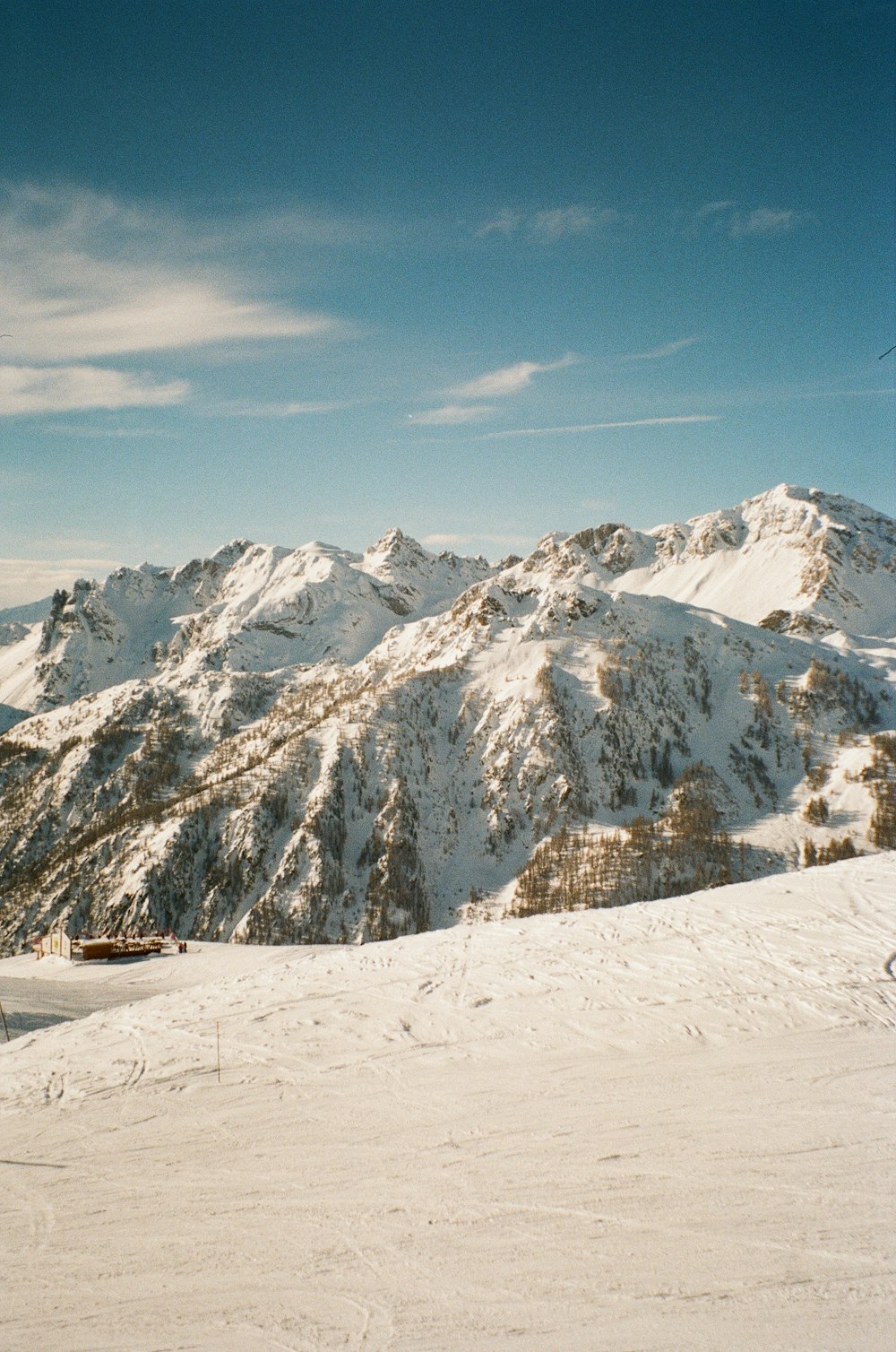 a person riding skis on top of a snow covered slope