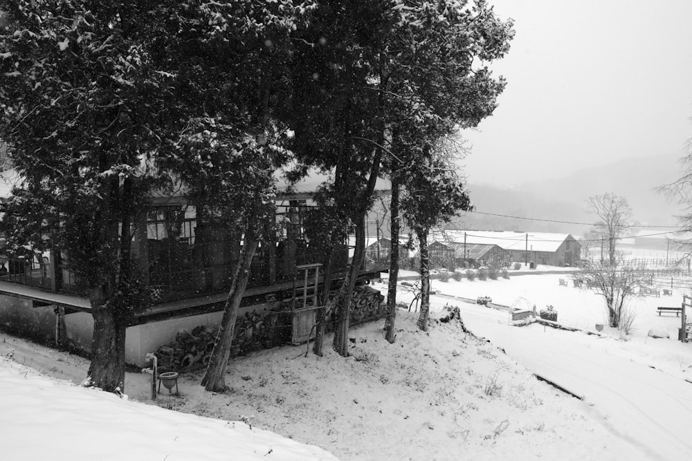 a black and white photo of a house in the snow