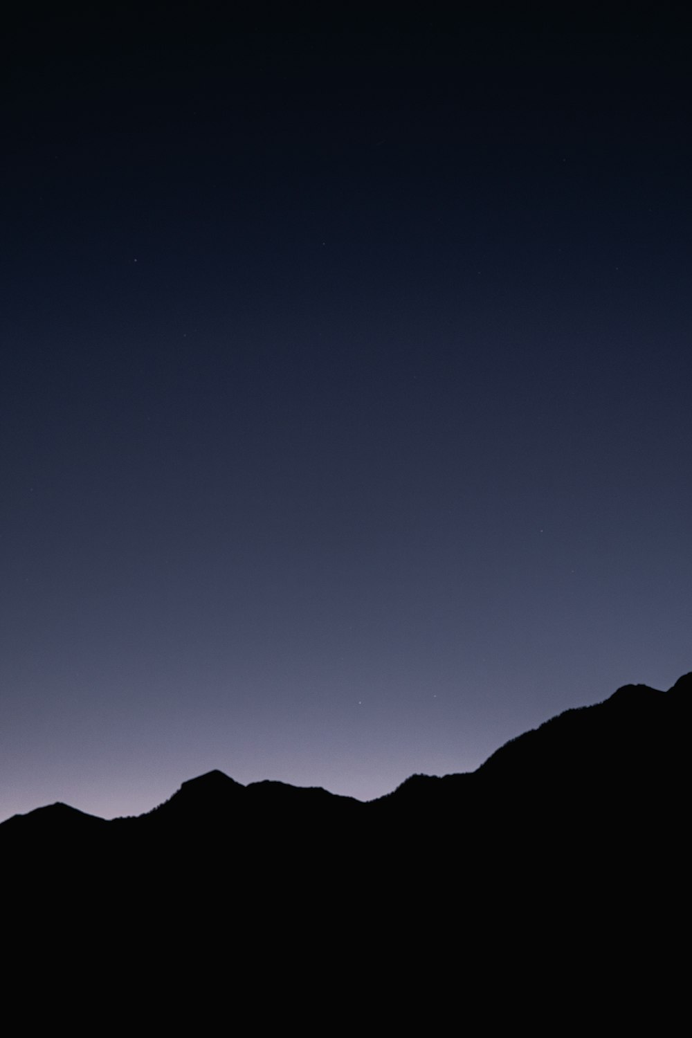 a plane flying over a mountain at night