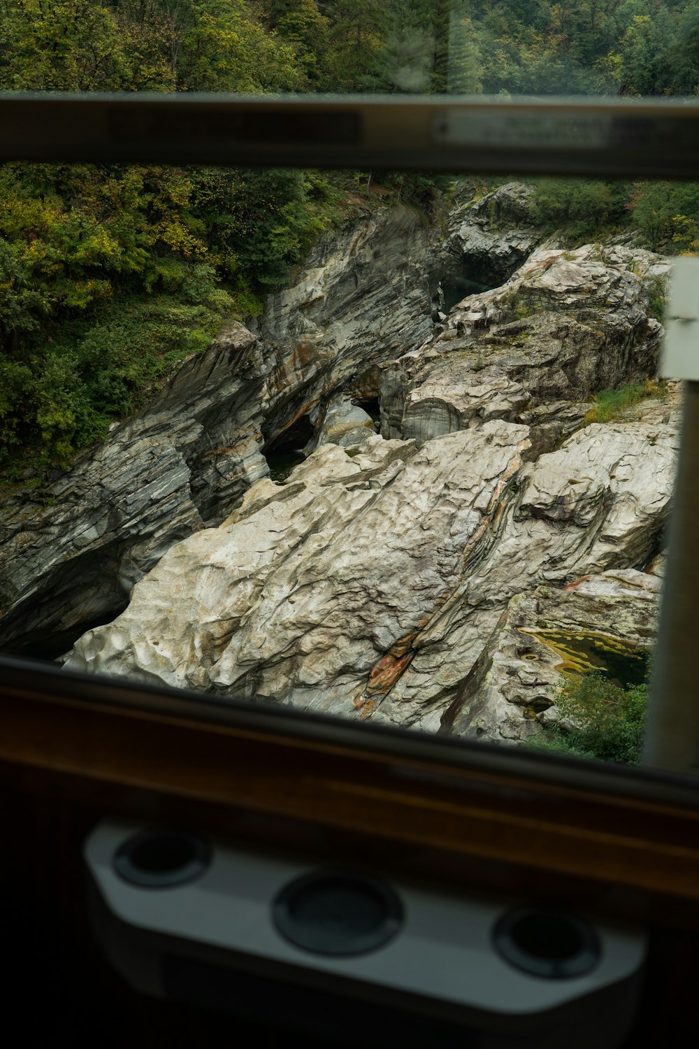 a view of a rocky river from a train window