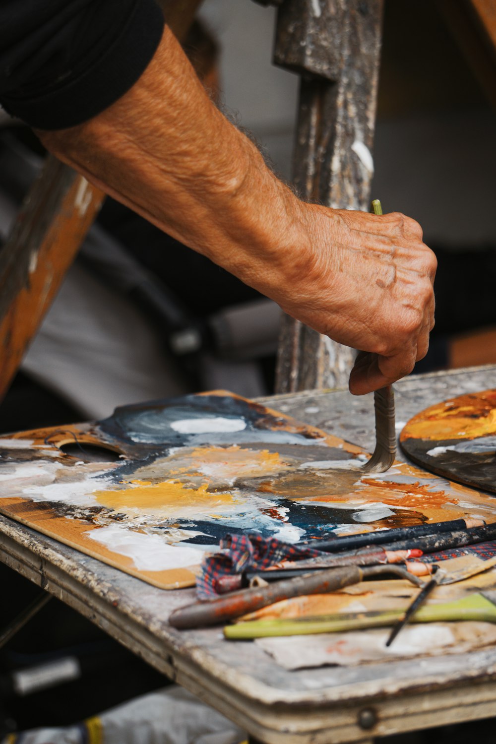 a man is using a knife to cut up a piece of art