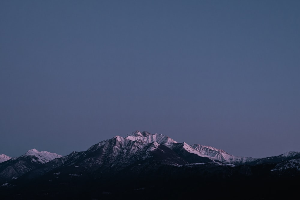 a view of a mountain range with snow on it