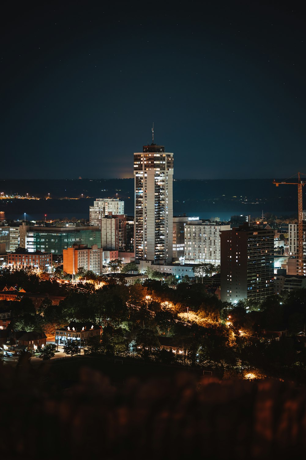 a night view of a city with tall buildings