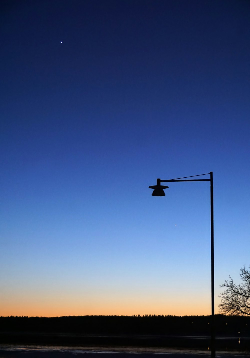 a street light on a pole with a sky in the background