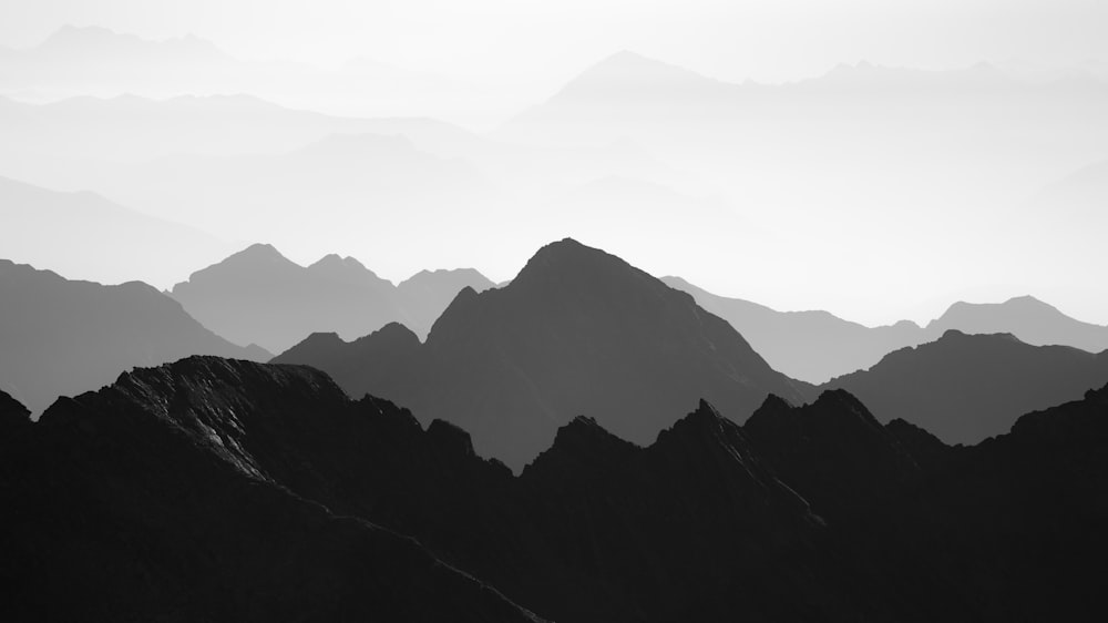 a black and white photo of a mountain range