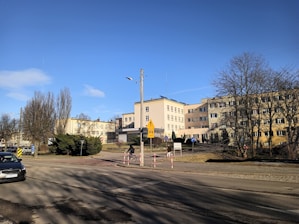 a city street with cars parked on the side of the road