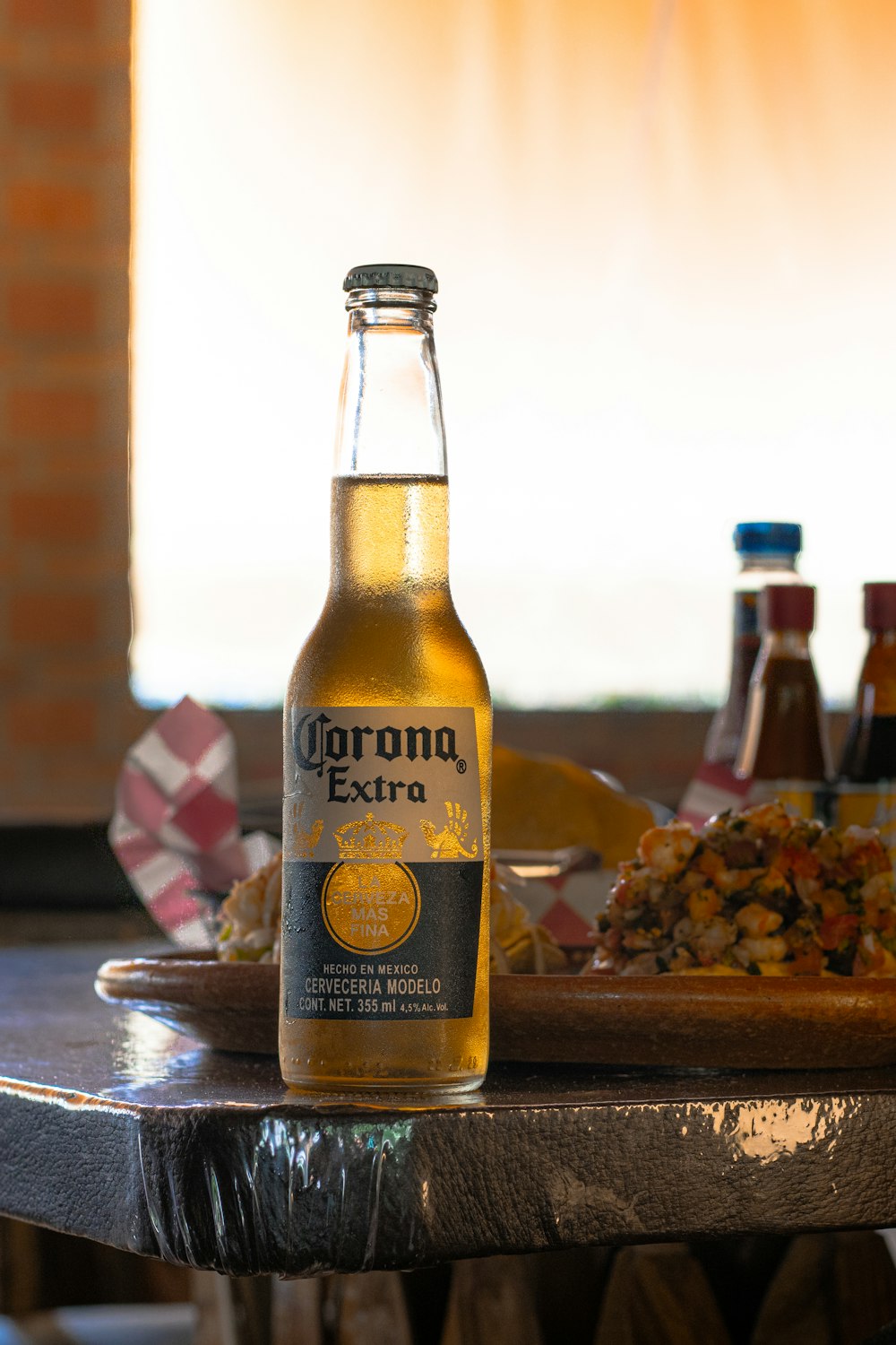 a bottle of corona extra beer sitting on a table