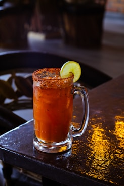 a drink with a slice of lime on top of it