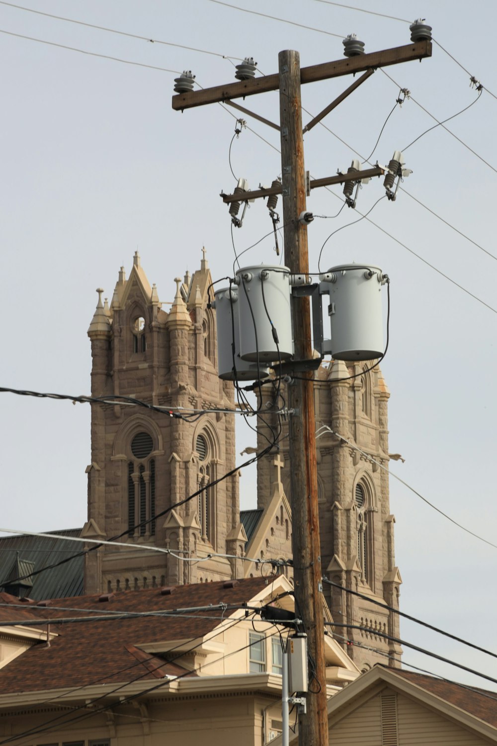 a couple of buckets sitting on top of a power pole