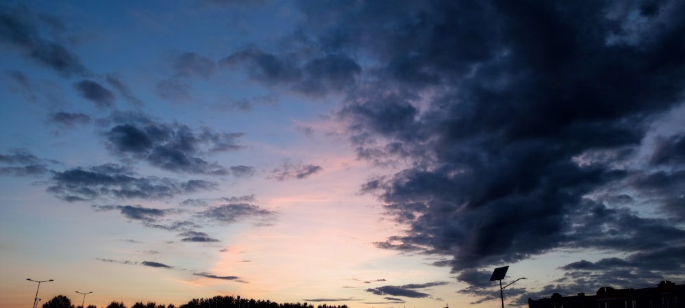 a cloudy sky is seen over a parking lot